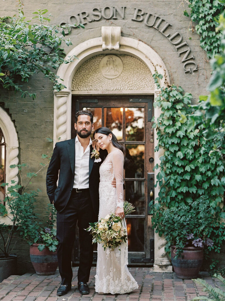 Bride and groom portrait on the steps of the Corson Building in Seattle, Washington